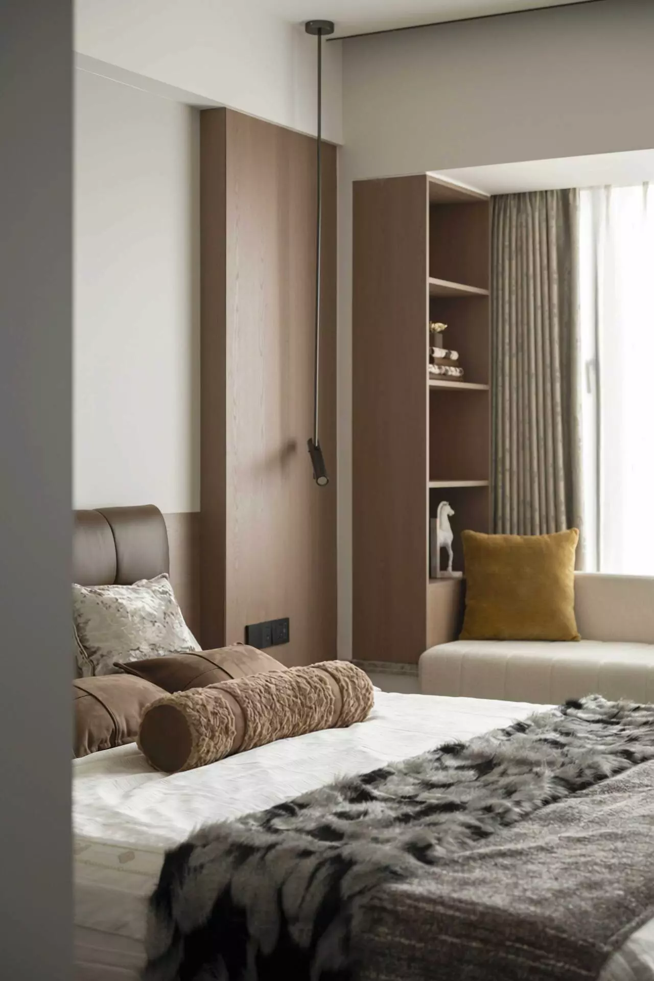 Elegant lighting integrated into master bedroom wood cabinetry