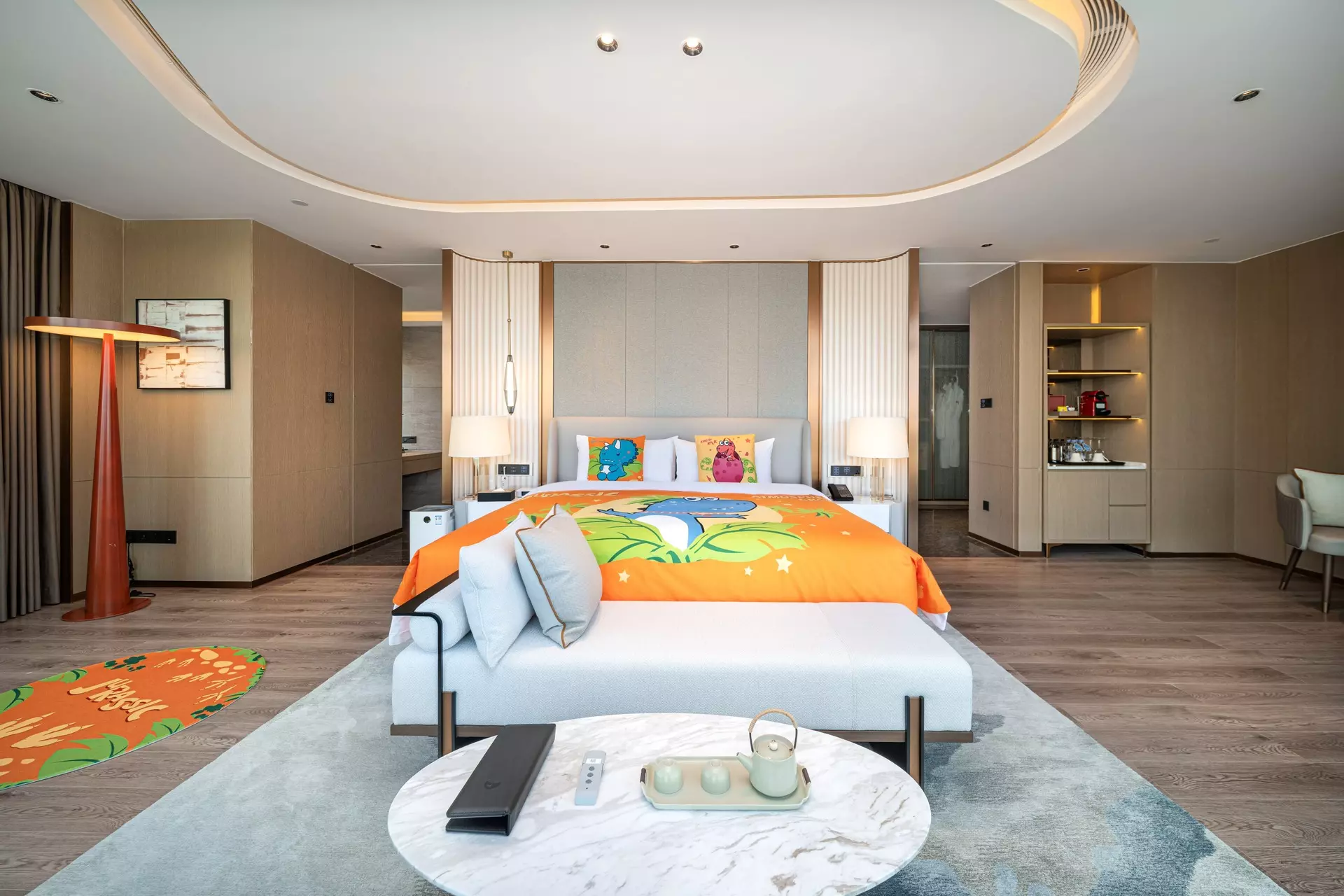 Luxury hotel suite bedroom with custom wood headboard and integrated lighting