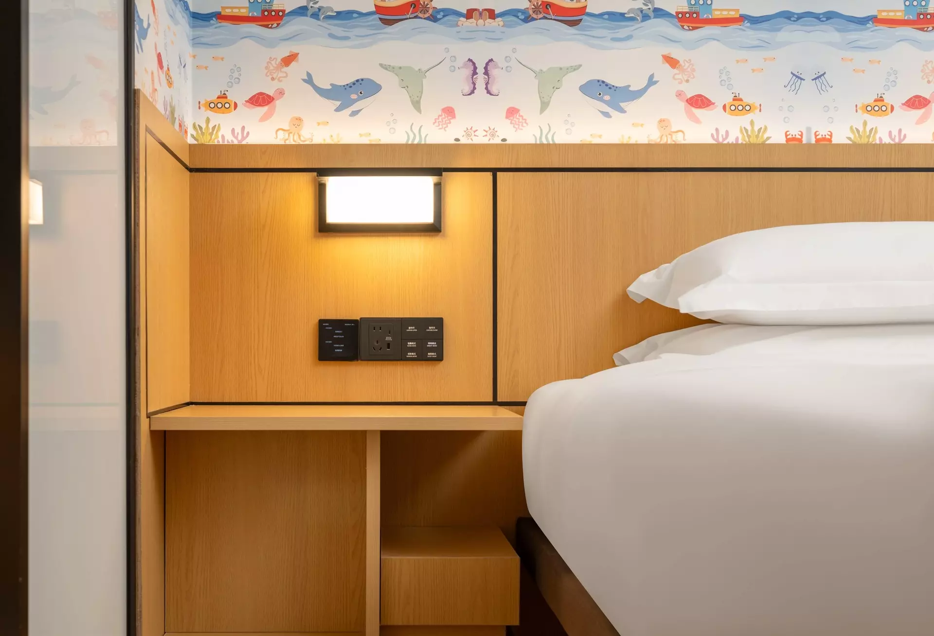 Custom architectural ceilings and coordinated wall fixtures in hotel arrival
